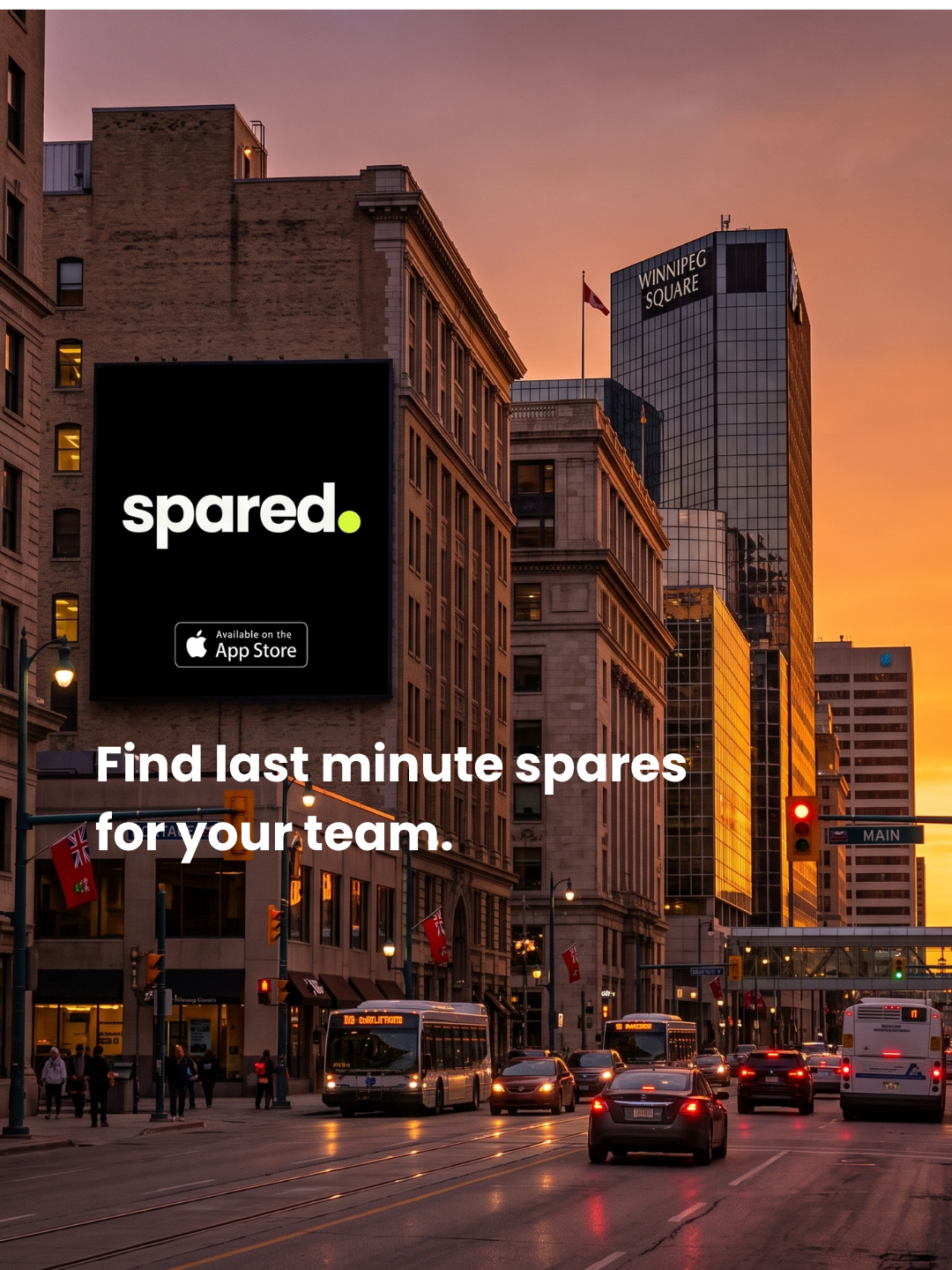 A Spared billboard lighting up a downtown Winnipeg street at dusk